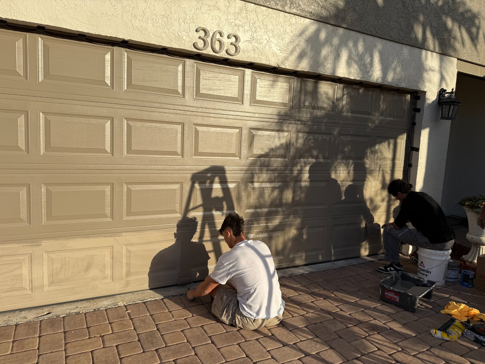 Team painting garage door